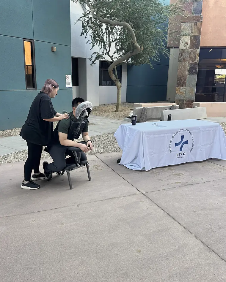 Chair massage by PISO at an outdoor community event