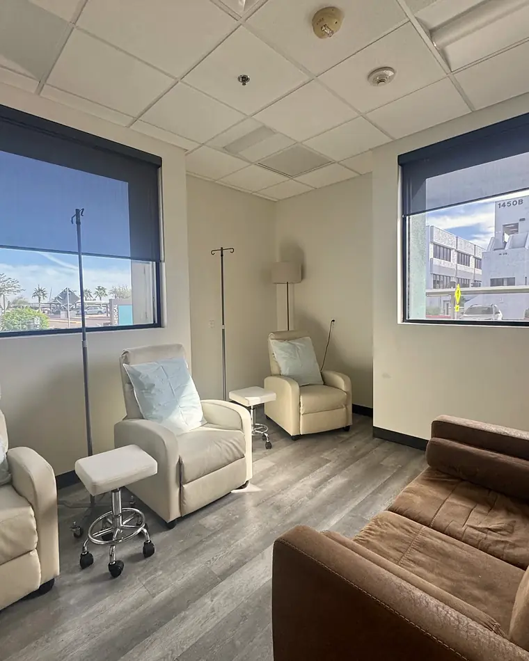 Two cream recliners in PISO's IV lounge beside a window