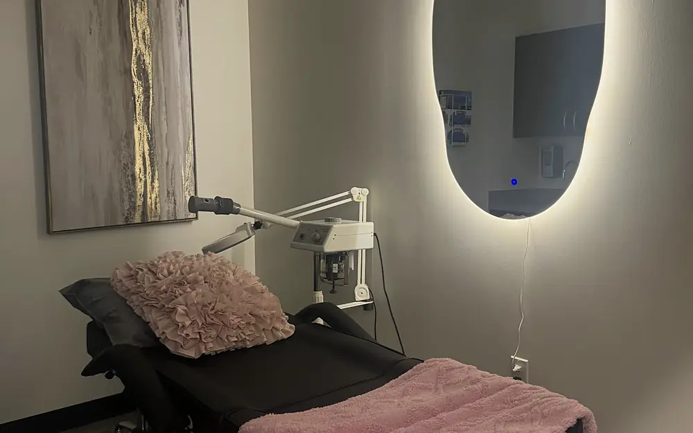 A calm PISO treatment room with a backlit mirror